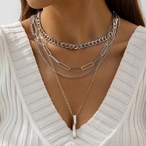 Silver multi-layer necklace set with paperclip chain, cuban links and bar pendant on model