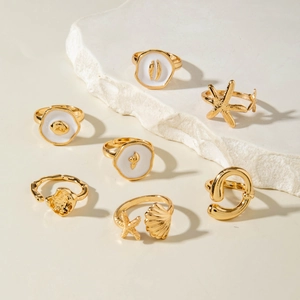 Golden ocean theme ring set featuring starfish shell and dolphin designs for women
