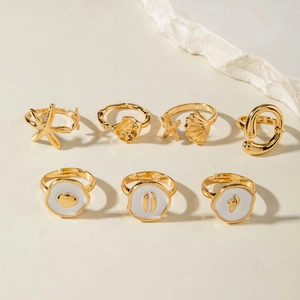 7-piece gold-plated ocean theme ring set featuring starfish and seashell designs