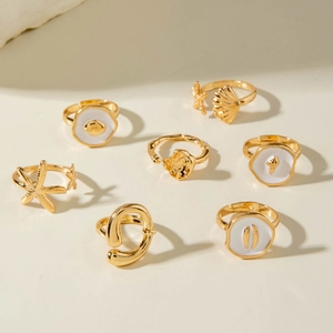 Macro shot of 7-piece gold ocean themed ring set with starfish and shell motifs