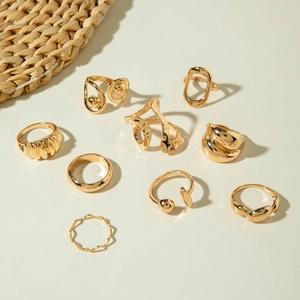 Nine-piece set of gold geometric open rings featuring irregular stacked designs