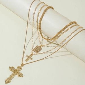 Layered gold cross necklaces featuring textured square pendant and vintage rope chains
