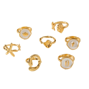 7-piece gold ocean themed ring set featuring starfish shell and white enamel designs