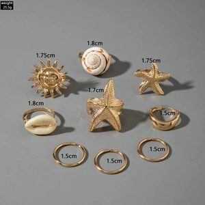 9-piece gold bohemian ring set featuring starfish and shells with diameter measurements