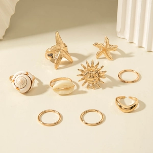 9-piece gold ocean themed ring set with starfish, sun, and seashell designs for beach style