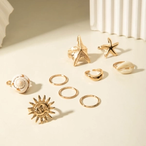 Nine-piece gold alloy beach ring set featuring starfish, shell, and sunflower designs