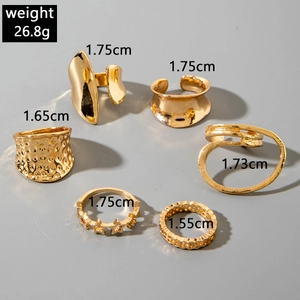 Detailed view of 6-piece gold alloy rings with geometric hollow and textured designs