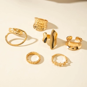 Set of six gold geometric fashion rings including hammered and hollow irregular designs