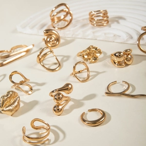 Detailed collection of assorted gold-plated geometric rings in floral and abstract shapes