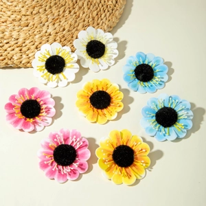 Close-up of assorted handmade sunflower and daisy accessories in four vibrant colors