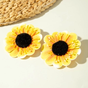 Detailed close-up of vibrant sunflower earrings with yellow petals and textured black centers