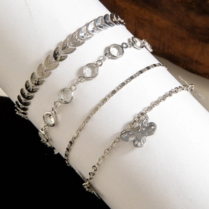 Detailed view of 4-piece silver-plated anklet set with butterfly and leaf charms