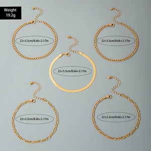 Detail view of 5-piece gold anklet set with Cuban, Figaro and snake chain textures