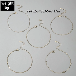 Detail view of gold-plated multi-layer anklet set with OT buckle and cross charms