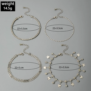 Detail view of 4-piece silver layered anklet set with butterfly charm and crystal stones