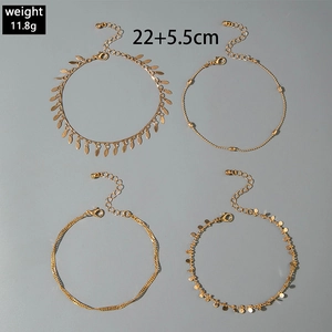 Detail of four-piece gold layered anklet set with cross charms and OT buckle