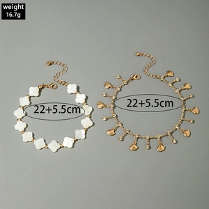 Detailed view of layered anklet with clover and shell pendants including dimensions and weight