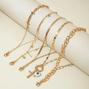 Five-piece gold layered anklet set with cross and evil eye crystal charms for women