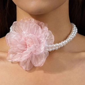 Close-up of double-strand pearl choker with a large pink organza flower detail
