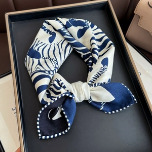 Navy and cream zebra pattern silk wool scarf displayed elegantly on a luxury display tray