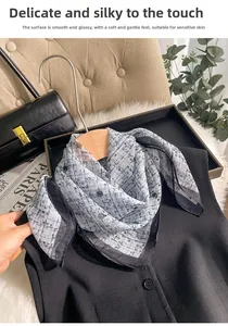 Close-up of blue-grey plaid silk scarf on hanger showing smooth and shiny texture
