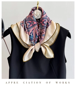Detail of vintage paisley silk scarf tied with a white camellia flower on black dress
