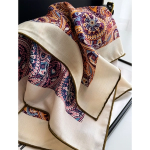 Silk wool scarf featuring colorful paisley patterns and herringbone weave texture