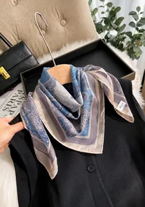 Detail of vintage paisley silk-like scarf draped elegantly over a black outfit