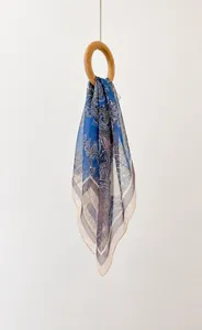 Detail view of paisley pattern silk chiffon scarf with 70x70cm dimensions and fine edge stitching