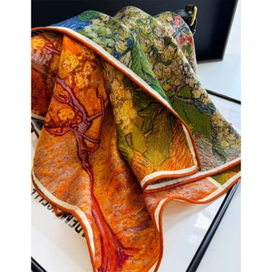 Detail of silk wool scarf with Monet painting print and rolled edges on a leather bag