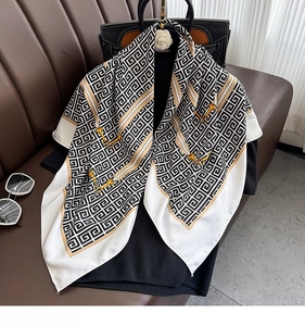Detail of square shawl with geometric Greek key patterns and golden horsebit prints