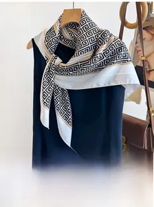 Detail view of twill silk scarf with geometric chain pattern tied on clothing