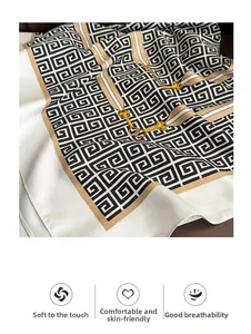 Detail of luxury geometric scarf showing soft fabric texture and golden horsebit chain design