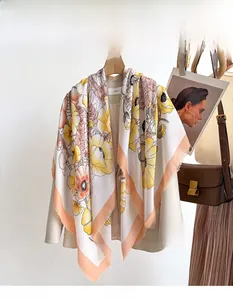 Detailed close-up of oversized floral print scarf with fringes and elegant office outfit