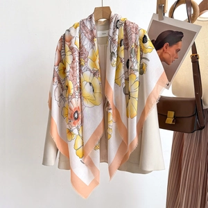 Detailed view of oversized floral print scarf draped elegantly over a beige blazer