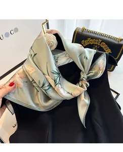 Detailed texture of 100% mulberry silk scarf with elegant white floral prints