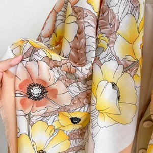 Close-up of floral print shawl showing soft fabric texture and fringe tassel detail