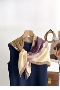 Detail showing vintage floral scarf in cream and purple satin tied on a navy top