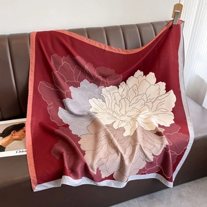 Detailed macro of large floral print scarf on leather background with elegant grey piping