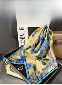 Macro detail of mulberry silk square scarf with vintage yellow floral pattern and smooth texture