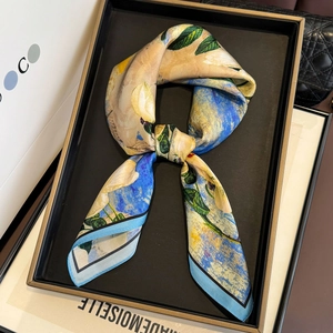Detail of silk square scarf featuring impressionist floral prints and hand-rolled edges