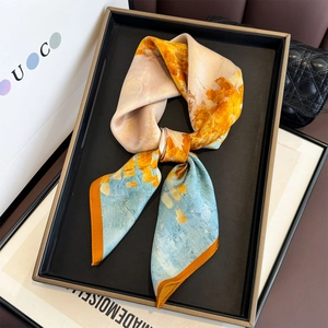 Abstract silk square scarf with blue and yellow oil painting patterns in a gift display