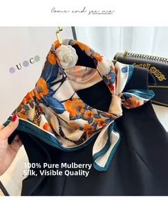 Detail of 100% mulberry silk scarf with floral pattern and dark green rolled edges