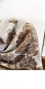 Detailed close-up of soft floral pattern and fine fabric texture on the elegant shawl