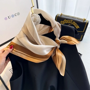 Elegant 65cm striped silk scarf in champagne and brown draped on a black dress