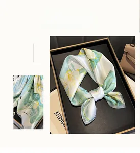 Detailed macro of premium lotus flower print on pure silk square scarf with satin finish