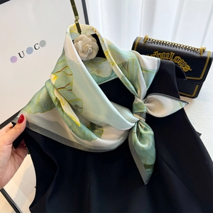 100% mulberry silk square scarf with lotus print styled on a black sleeveless top
