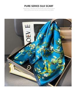 Close-up of blue Van Gogh almond blossom print 100% mulberry silk scarf on display