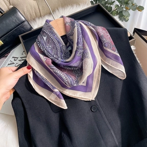 Purple paisley silk chiffon scarf styled on a black vest for a chic fashion look