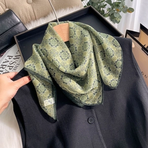 Retro green printed chiffon silk scarf styled on a black vest for a fashion look